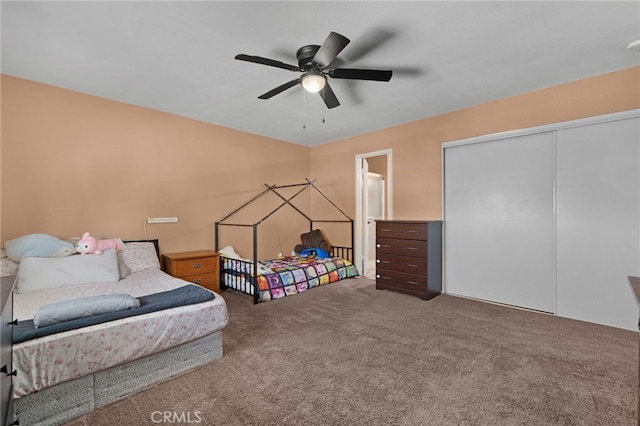 bedroom with ceiling fan, a closet, and carpet floors