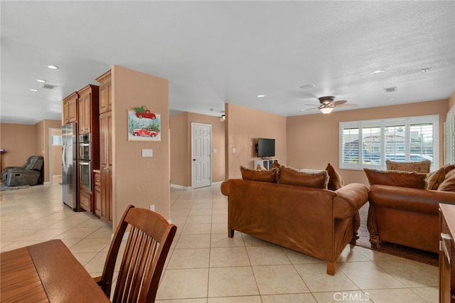 tiled living room featuring ceiling fan