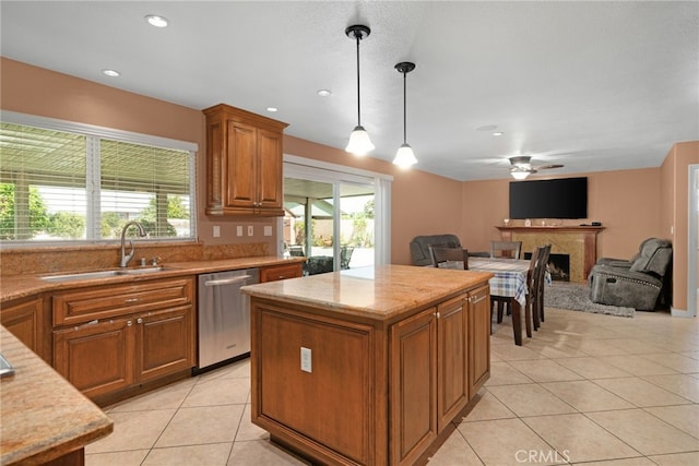 kitchen featuring decorative light fixtures, stainless steel dishwasher, a healthy amount of sunlight, and sink