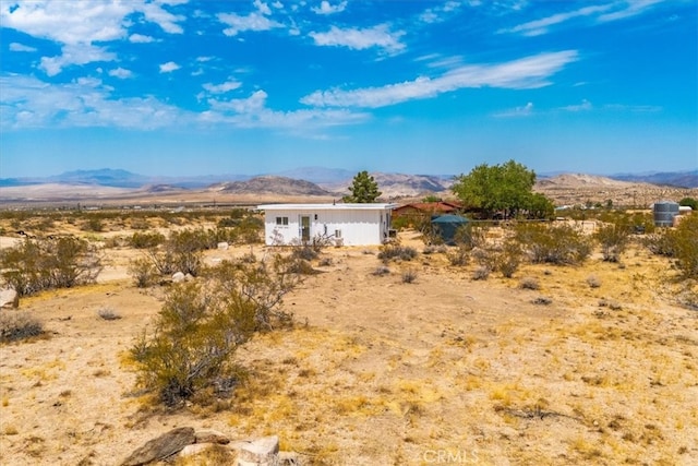 rear view of house featuring a mountain view