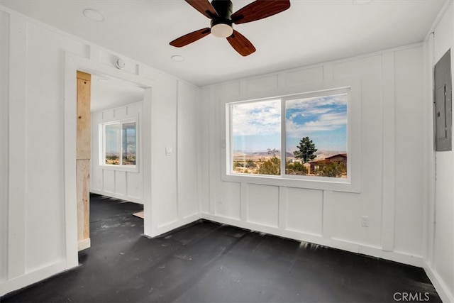 unfurnished room with electric panel, plenty of natural light, and ceiling fan