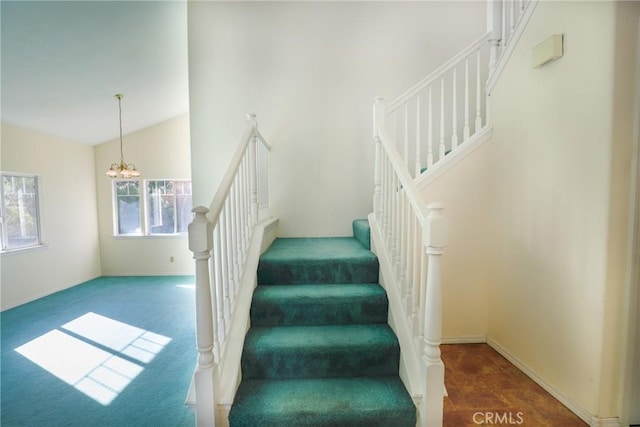 stairs featuring high vaulted ceiling and a chandelier