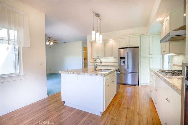 kitchen featuring hanging light fixtures, sink, ceiling fan, an island with sink, and appliances with stainless steel finishes