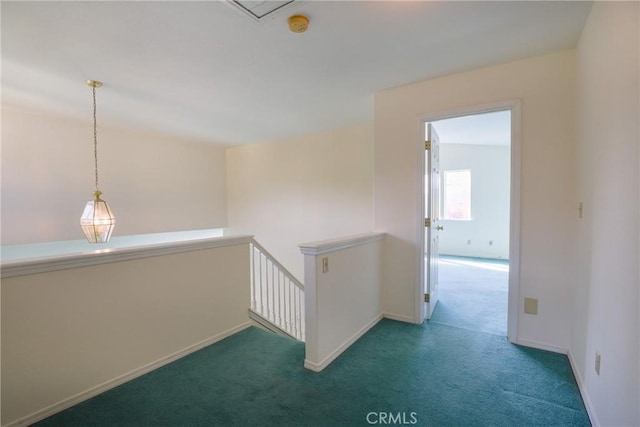 hall with vaulted ceiling and dark carpet