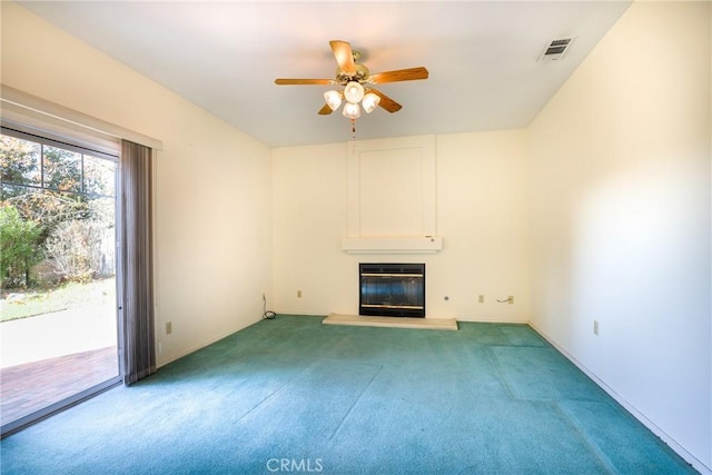 unfurnished living room with a wall unit AC, ceiling fan, and carpet