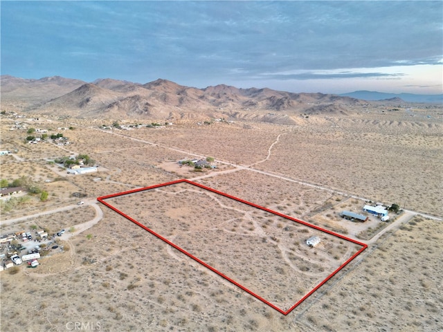 birds eye view of property featuring a mountain view