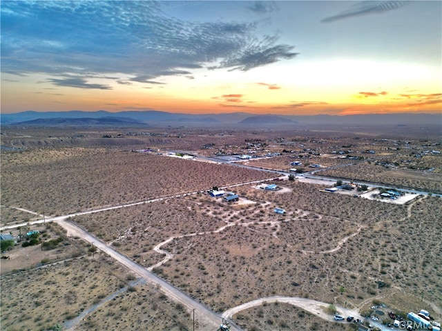 aerial view at dusk featuring a mountain view