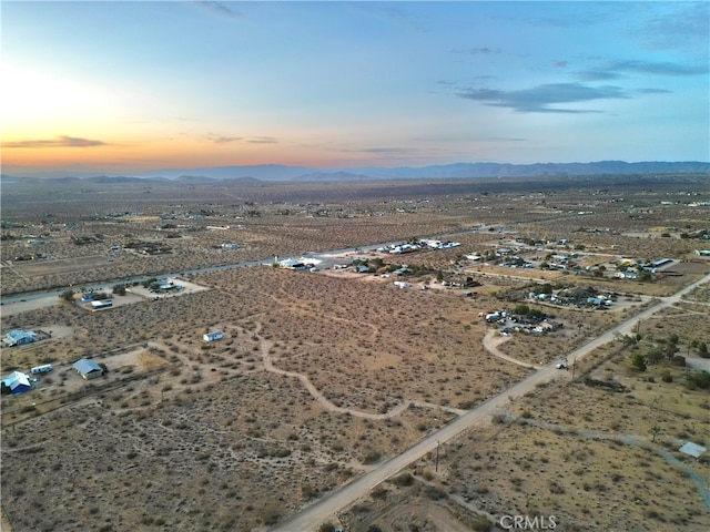 aerial view at dusk featuring a mountain view