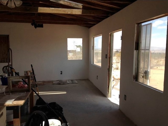 interior space with lofted ceiling and ceiling fan