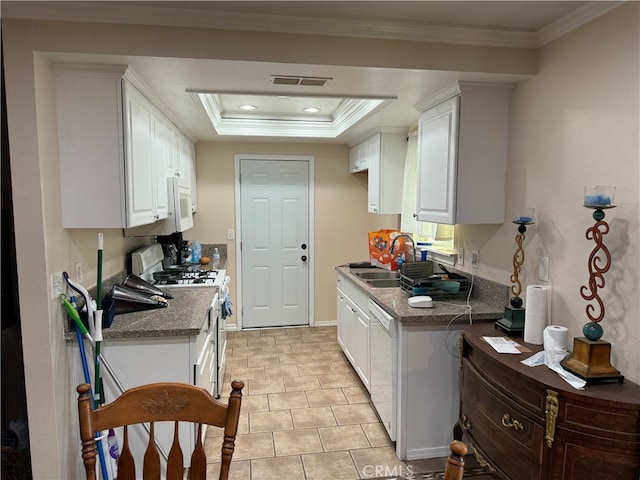 kitchen featuring sink, white cabinetry, a tray ceiling, and white appliances