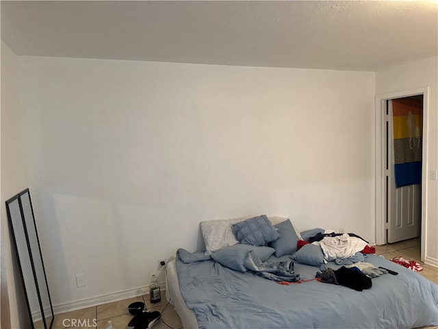 bedroom with light tile patterned floors