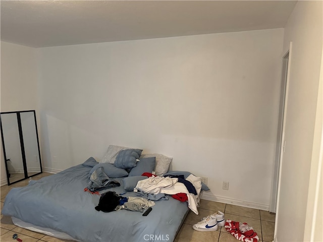 bedroom with light tile patterned floors