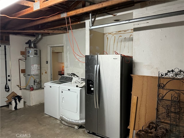 utility room with water heater and washer and dryer