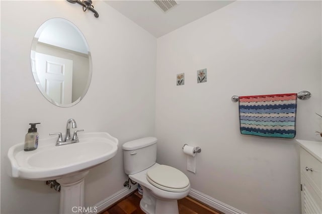 bathroom featuring toilet and hardwood / wood-style floors