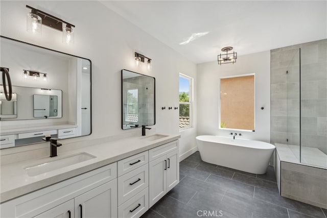 bathroom with shower with separate bathtub, vanity, and tile patterned floors