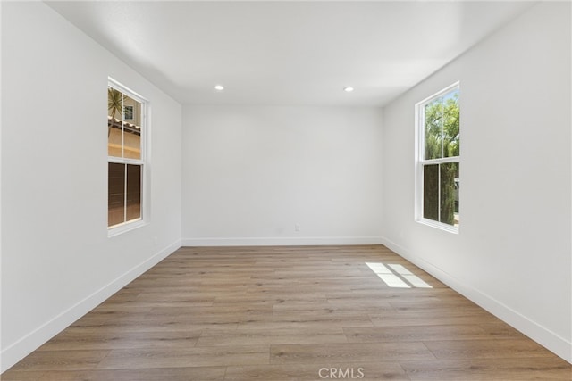 spare room featuring light hardwood / wood-style floors