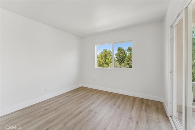 unfurnished room with light hardwood / wood-style floors