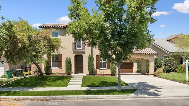 mediterranean / spanish-style home featuring a garage and a front yard