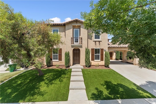 mediterranean / spanish-style house with a balcony and a front lawn