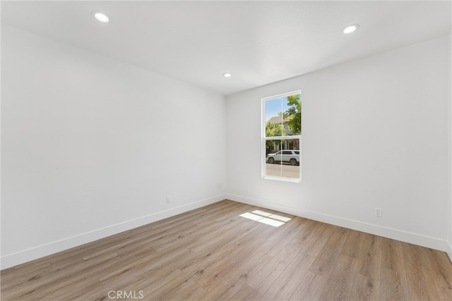 unfurnished room with light hardwood / wood-style flooring