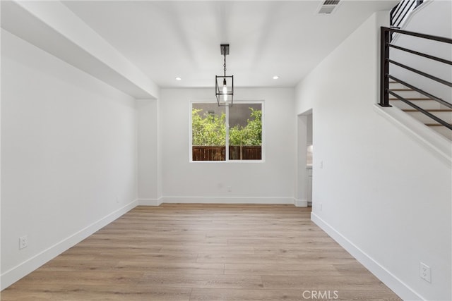 interior space with light wood-type flooring and a chandelier