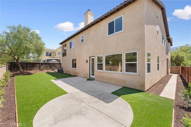 rear view of property with a patio area and a yard