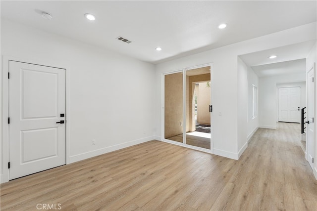 spare room featuring light hardwood / wood-style floors