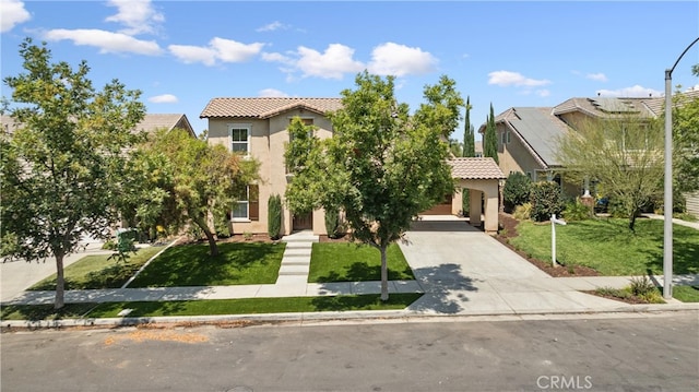 mediterranean / spanish home featuring a front lawn