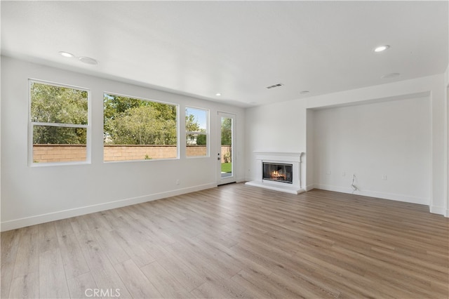 unfurnished living room with light hardwood / wood-style floors