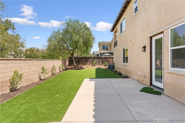 view of yard with cooling unit and a patio