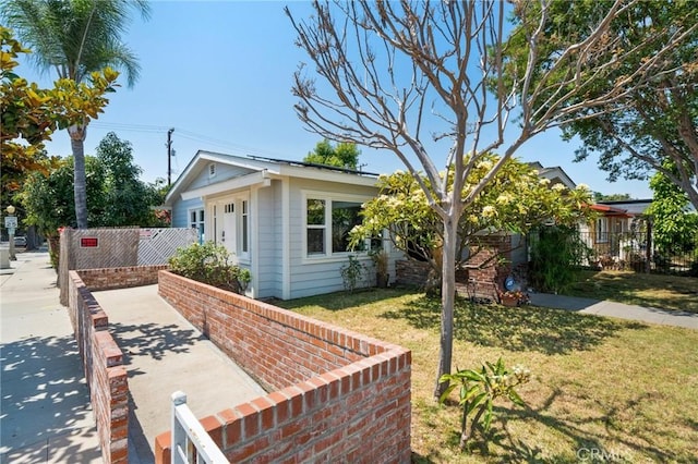 view of side of home with a lawn