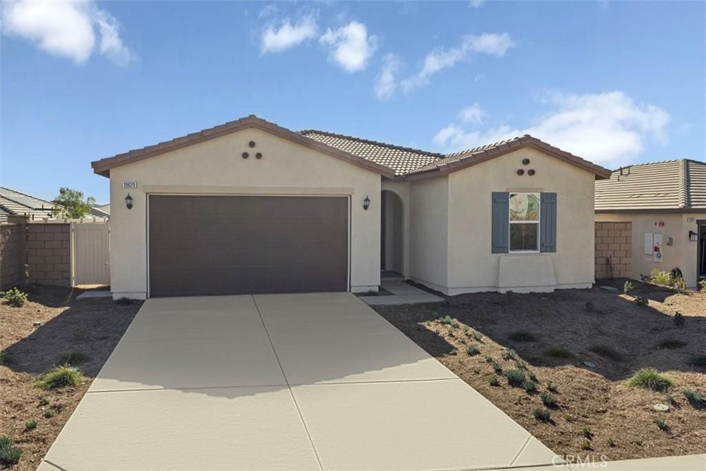 mediterranean / spanish-style house with a garage