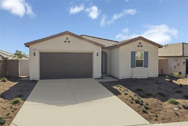 mediterranean / spanish-style house with a garage