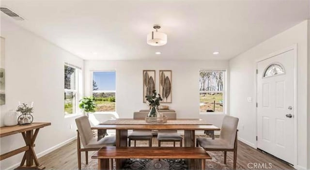 dining space with dark hardwood / wood-style flooring