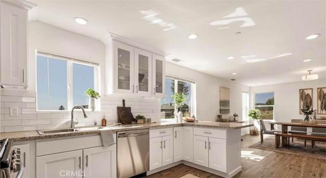 kitchen with dark hardwood / wood-style floors, sink, stainless steel appliances, and white cabinets