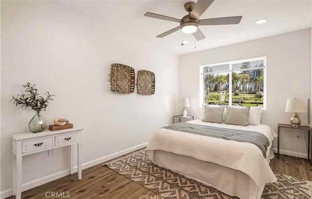 bedroom featuring ceiling fan and dark wood-type flooring