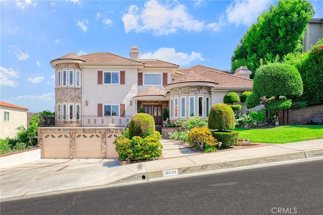 mediterranean / spanish-style house featuring a garage