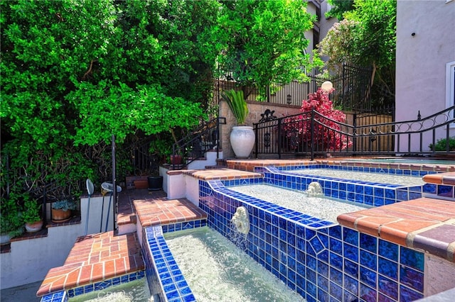 view of swimming pool featuring a patio and pool water feature