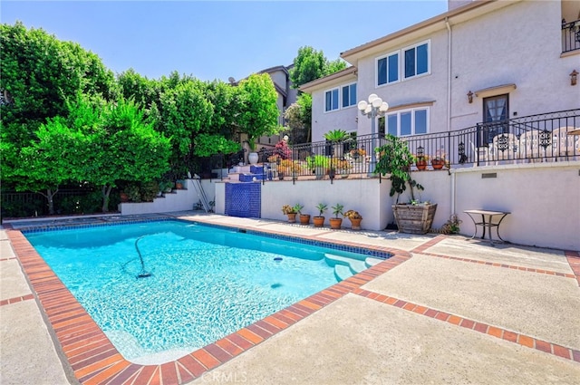 view of swimming pool with a patio