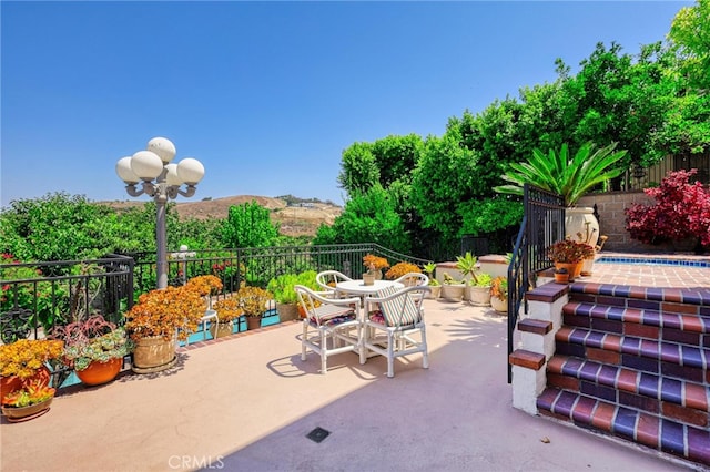 view of patio / terrace with a mountain view