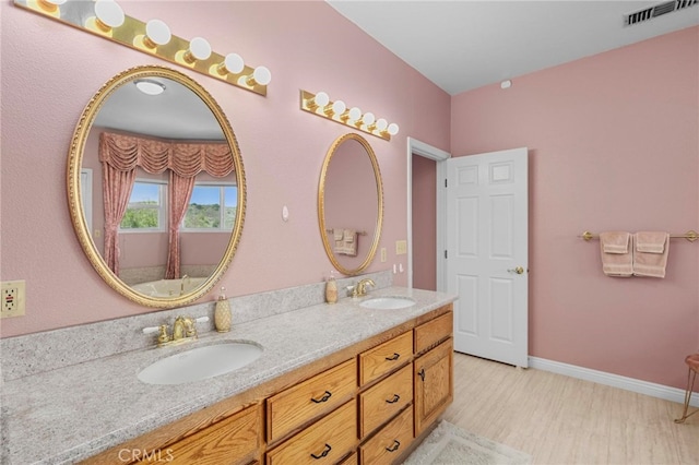 bathroom with vanity and hardwood / wood-style floors