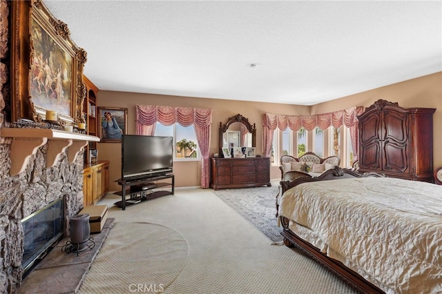 carpeted bedroom featuring a fireplace