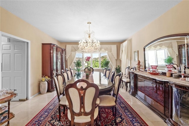 tiled dining room with a wealth of natural light, a chandelier, and a textured ceiling