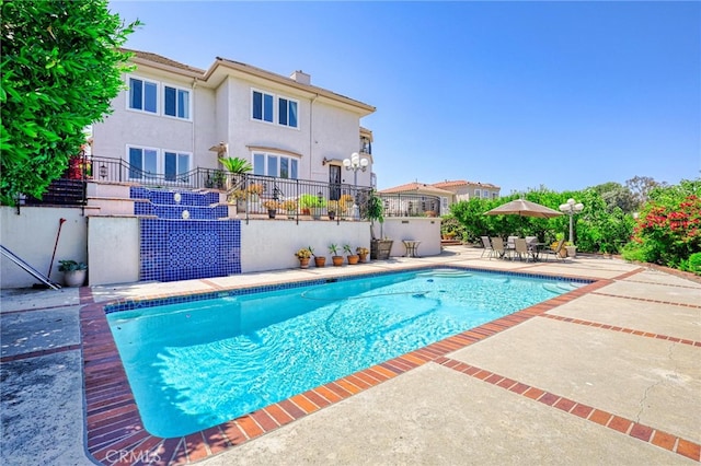 view of swimming pool with a patio