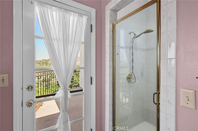 bathroom featuring a shower with door