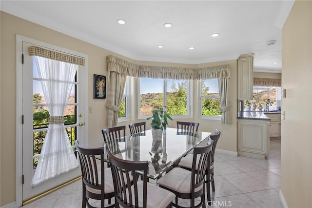 dining room featuring a wealth of natural light, crown molding, and light tile patterned floors