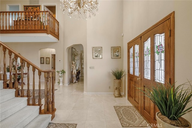 tiled foyer featuring a high ceiling and french doors