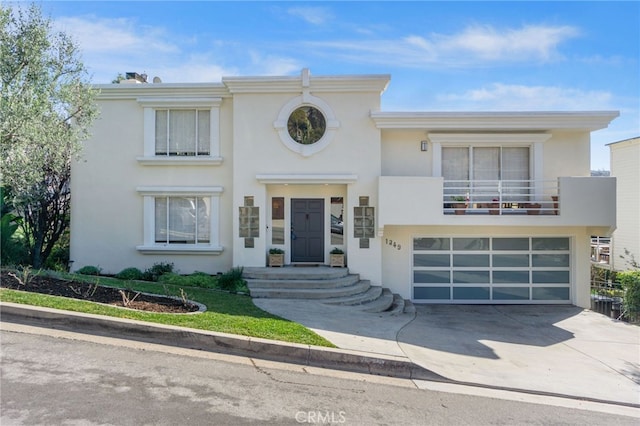 view of front of home with a garage and a balcony