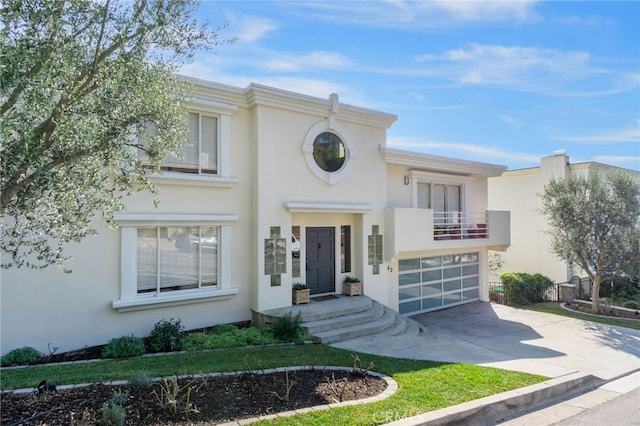 view of front facade with a garage and a balcony