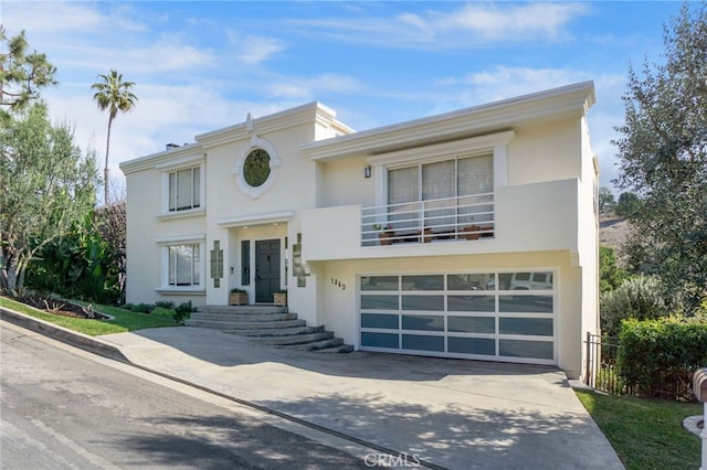 view of front of house featuring a garage and a balcony